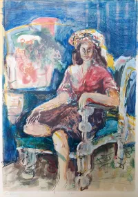 Woman-sitting-in-an-armchair-on-a-blue-background